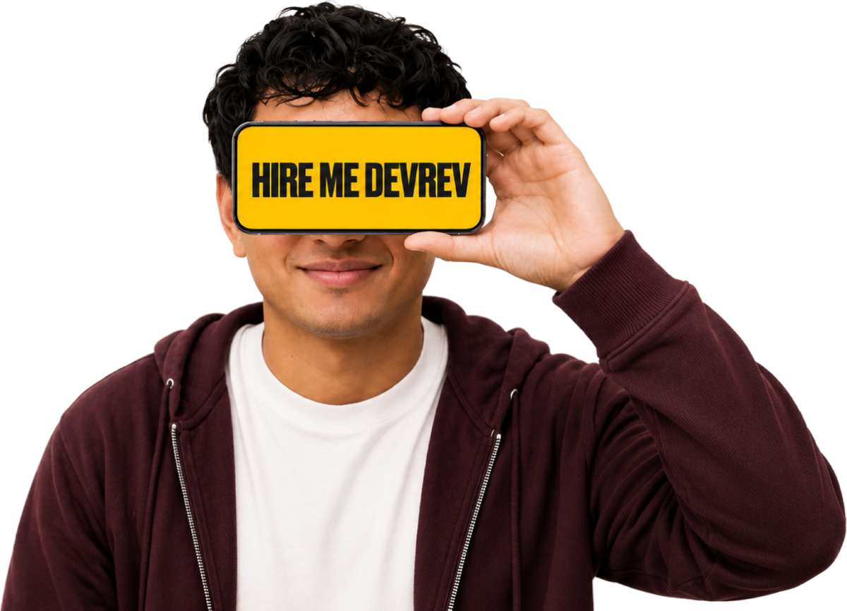 Yash holding a phone that reads: hire me DevRev